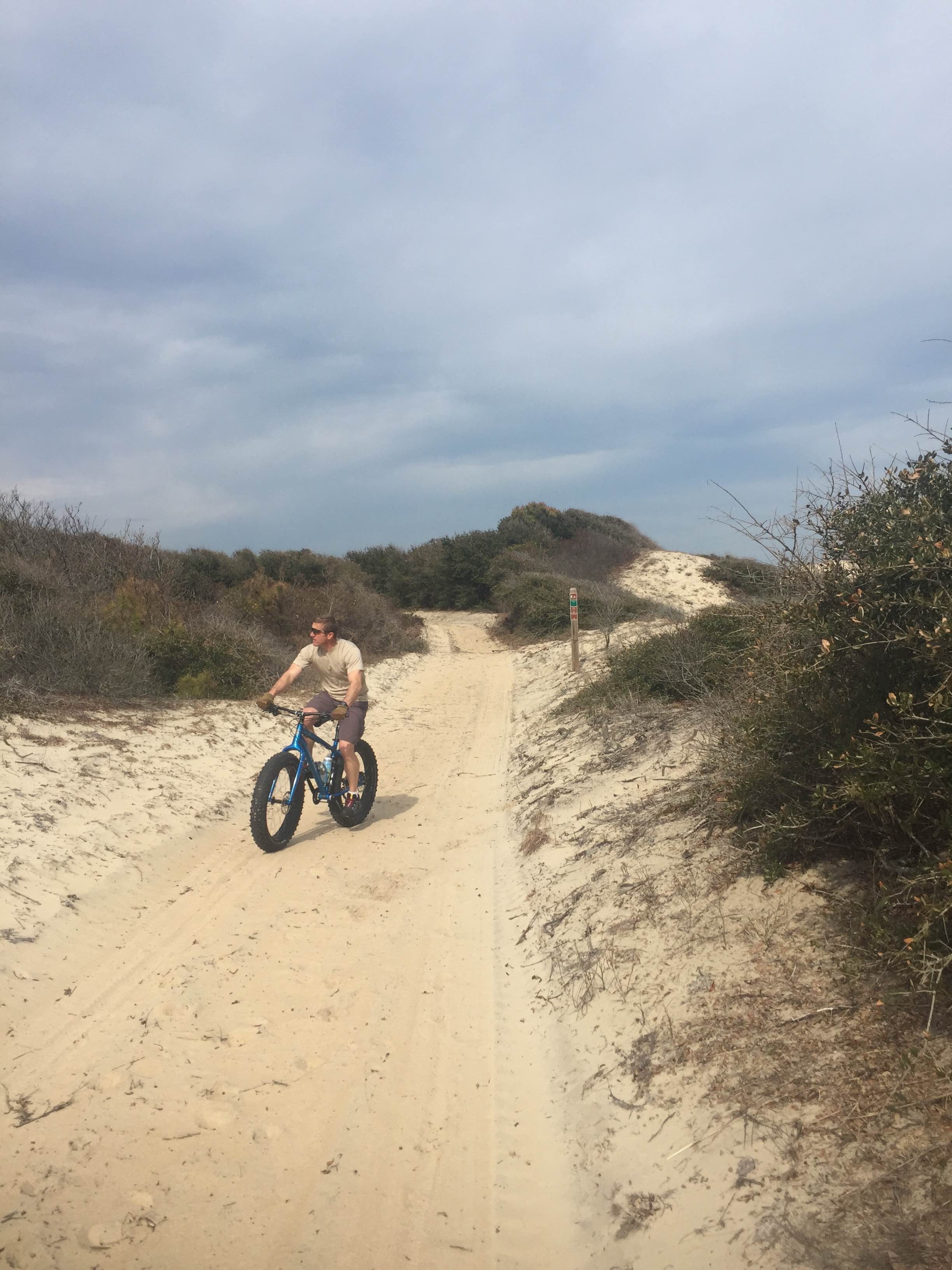 Friend of the shop, Craig Thomas, rolling over the sand on his Kona Wo far from any pavement.