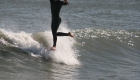 Evan Micele surfing a longboard in Virginia Beach.